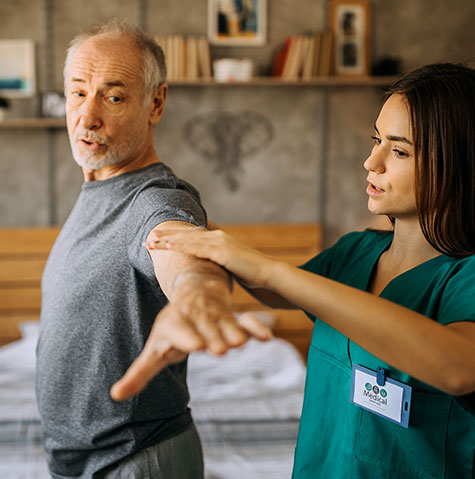 Patient does arm exercises with home healthcare nurse at home